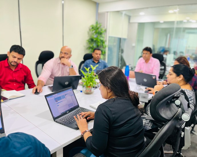Triazine Software team collaborating in a meeting