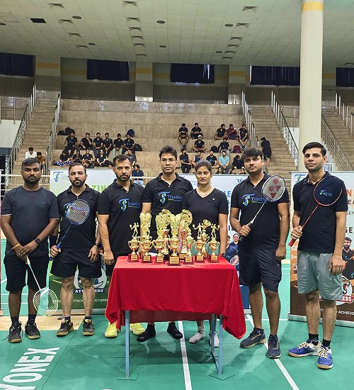 Triazine Software team celebrating badminton tournament wins